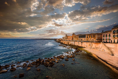 Spectacular sunset over the sea with maniace castle