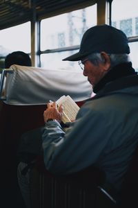 Side view of man sitting in bus