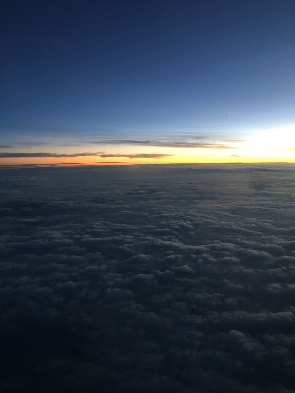 AERIAL VIEW OF CLOUDSCAPE AGAINST SKY DURING SUNSET