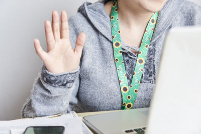 Midsection of woman using laptop