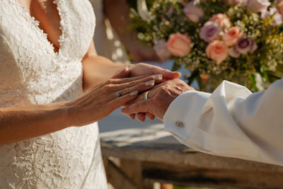 Midsection of couple holding hands