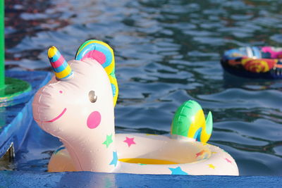 A swimming circle in the form of a unicorn is floating in the pool. concept of summer holidays