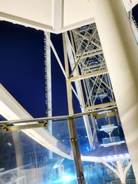 Low angle view of illuminated bridge against blue sky