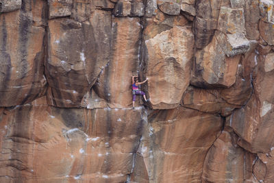 Full length of young woman on cliff