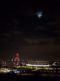 Illuminated city against sky at night