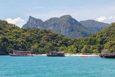 Scenic view of sea and mountains against sky