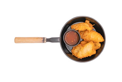 Directly above shot of bread in container against white background