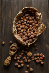 Autumn hazelnuts and walnuts on wooden table. top view.