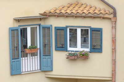 Window and balcony with blue wooden shutters