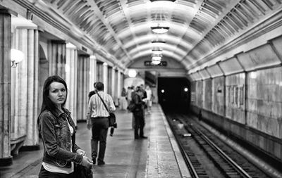 People waiting at railroad station platform
