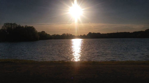 Sun shining over lake