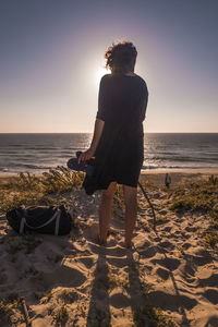 Rear view of man standing on beach