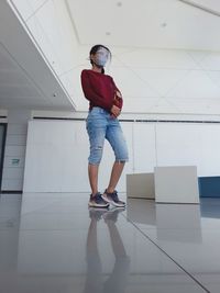 Full length of woman standing on tiled floor