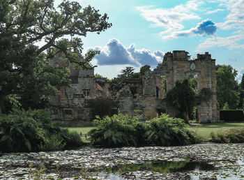 Pond by abandoned fort against sky