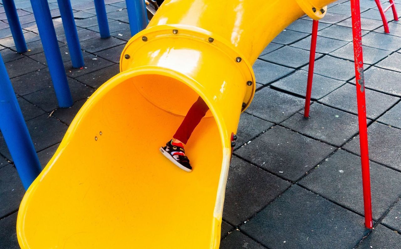 yellow, transportation, mode of transport, orange color, high angle view, metal, close-up, red, railing, day, outdoors, empty, protection, part of, sunlight, absence, travel, playground, no people, safety