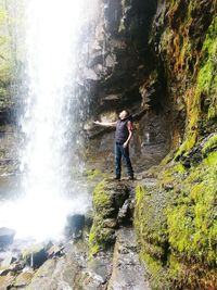 Full length of woman standing in forest