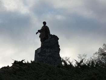 Low angle view of statue against sky