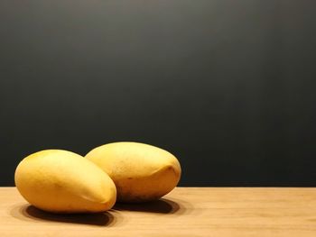 Close-up of apple on table against black background