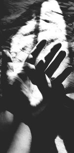 High angle view of person hand on shadow