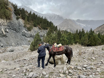 Man standing by mountains against sky