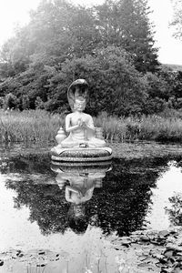 Boy standing by lake