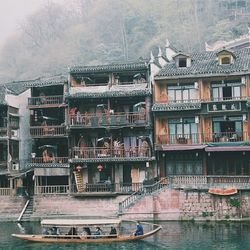 Boats in river with buildings in background