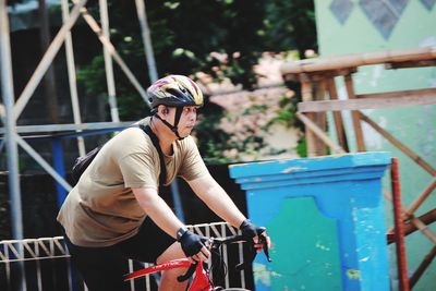 Full length of man with bicycle standing on railing