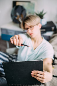 Midsection of man using mobile phone