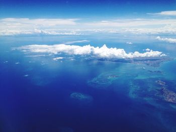 Aerial view of sea against blue sky