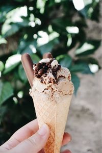 Close-up of hand holding ice cream cone
