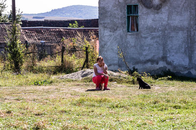 Rear view of woman with dog on plant