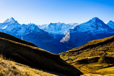 Scenic view of mountains against clear blue sky