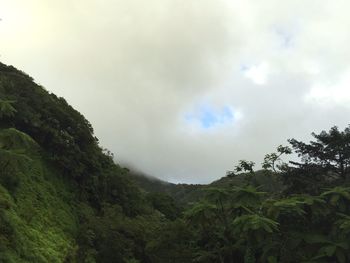 Scenic view of mountains against cloudy sky