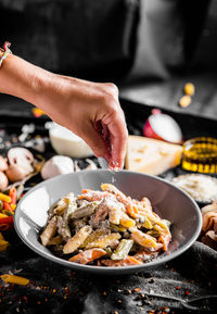 Midsection of person preparing food on barbecue grill