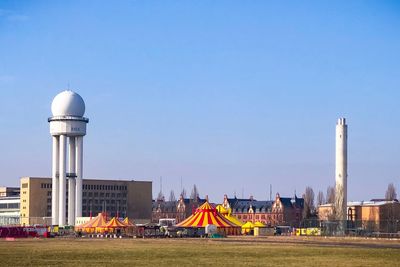 Buildings and towers against clear sky