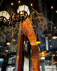 Low angle view of illuminated pendant lights hanging from ceiling