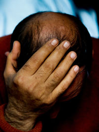 Depressed man with head in hands