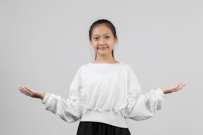 Portrait of a smiling girl over white background