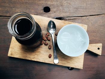 Still life with coffee beans and black liquid in jar