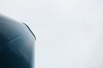 Close-up of airplane flying against clear sky