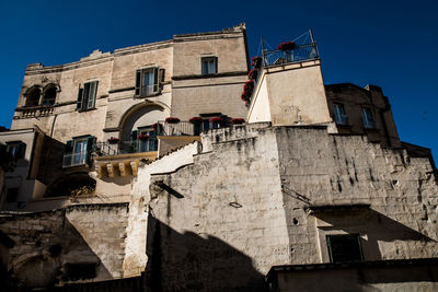 Low angle view of old building against blue sky