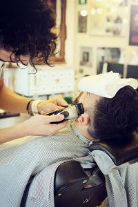 Man cutting male customer hair