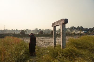 Girl stands infront of monolithic structure