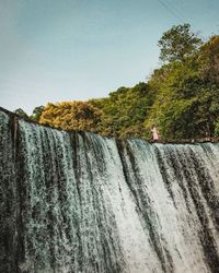 Scenic view of waterfall against clear sky