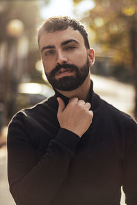 Portrait of young man standing outdoors