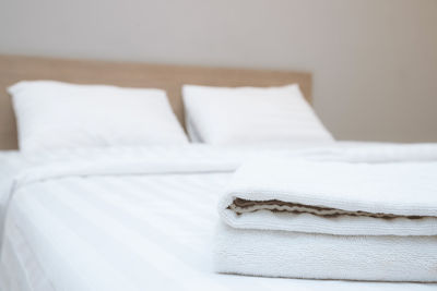 Close-up of white fabric on bed at home