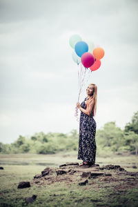 Woman holding balloons