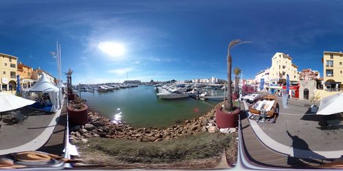 Sailboats moored at harbor