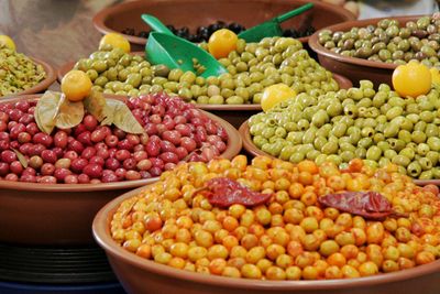 High angle view of colorful olives in container for sale