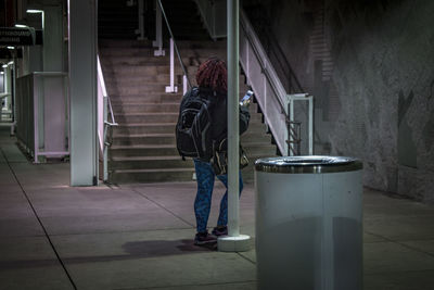 Woman using mobile phone at subway station